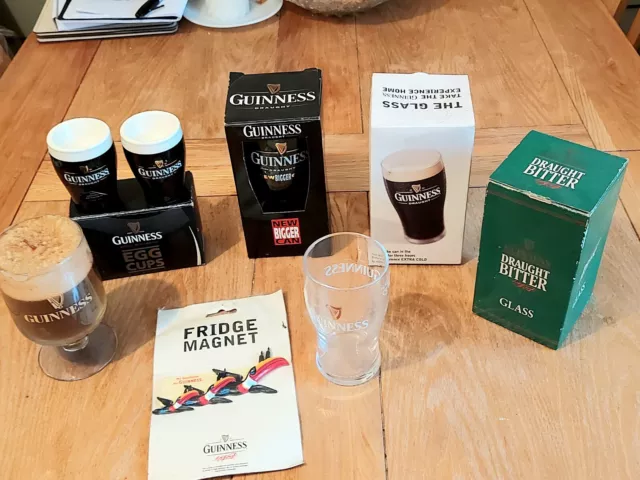 Nice Collection Of Guinness Collectables Inc Egg Cups, Glasses Candle Toucan Bar