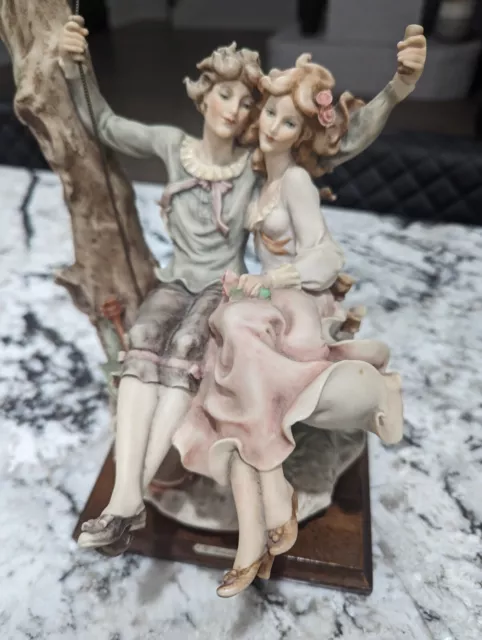 Giuseppe Armani - Capodimonte "Young Lovers On A Swing". Signed. Florence 1983.