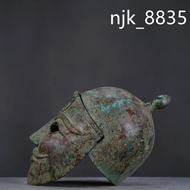 old Ancient China antique bronze carving Zhan Han period Human face Helmet old Ancient China antique bronze carving Zhan Han period Human face Helmet
