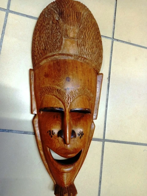 Mask wall wooden carved tree-African motifs.