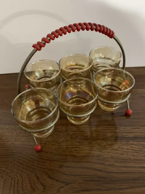 Set of 6 vintage gold colored glass shot glasses in metal caddy with red accents