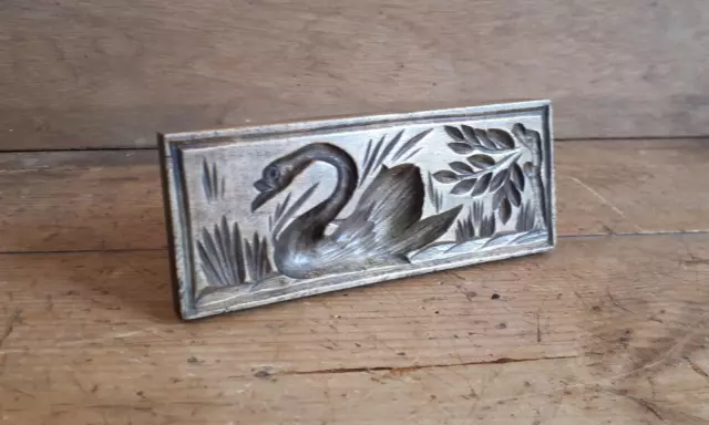 A good 19thC rectangular sycamore butter stamp depicting a swan on river or lake