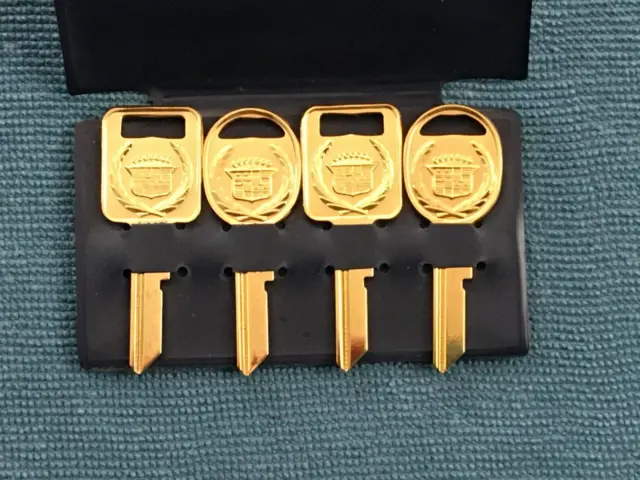 NOS Cadillac Crest Set of Four Gold Plated / Color Keys, Vintage Uncut Blank