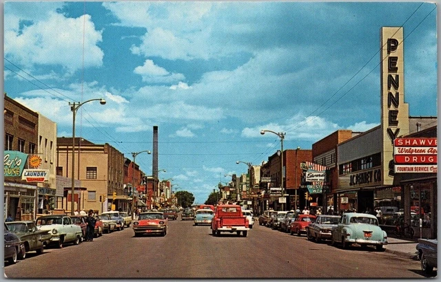 1950s LARAMIE, Wyoming Postcard Downtown Scene "Gateway to the Snowy Range"