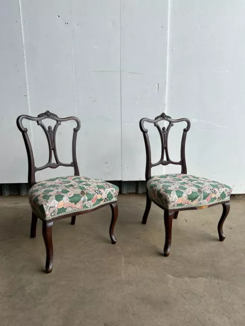 A pair of Victorian carved mahogany parlour chairs