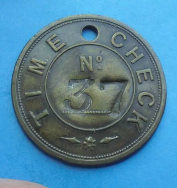 Large Time Check Engineering Token No. 37, 34mm dia, as shown.