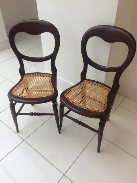 Antique pair of balloon back Hall/Bedroom/Side chairs with cane weaved seat.