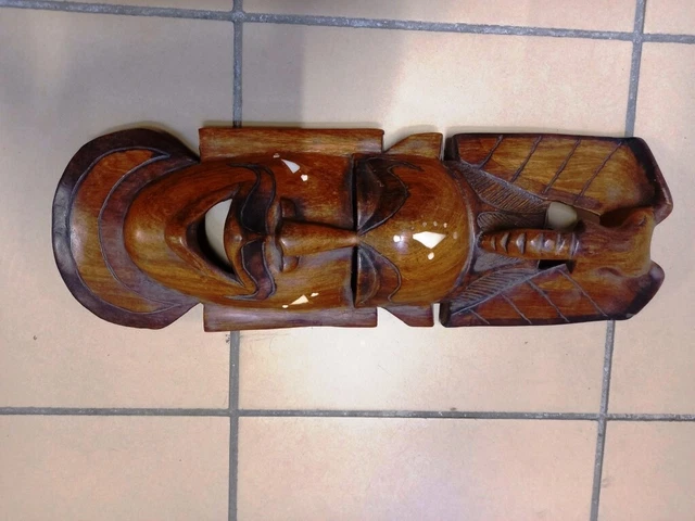Mask wall wooden carved tree-African motifs.