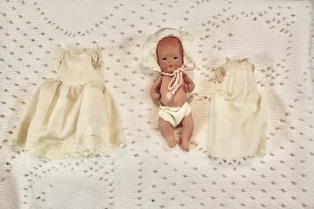 VINTAGE KERR & HINZ 4" BISQUE jointed arms legs baby doll in white dress