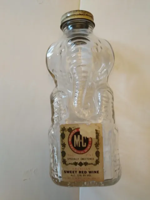 Vintage Figural Elephant bottle with coin bank lid, and with Covington,Ky. label