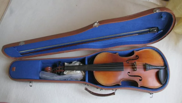 Old violin with Stradivarius label inside, with case and bow