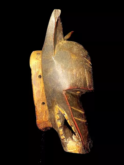 Maschera africana antica intagliata a mano in legno con decorazioni murali...