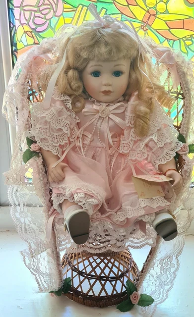 Leonardo Collection Pretty Porcelain Doll - Nicola - sat in large Peacock chair