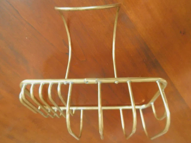 Vintage brass soap and sponge holder for a ball and claw tub.