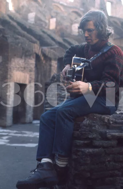 Vintage 1972 35mm photo slide of young man playing guitar at the Rome Colosseum