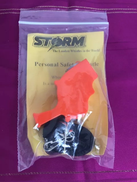 Storm safety whistle, orange in color with lanyard  New in package
