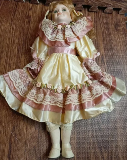Vintage 19" Tall Porcelain Doll Green Glass Eyes ,Blonde hair. Dress cream/pink