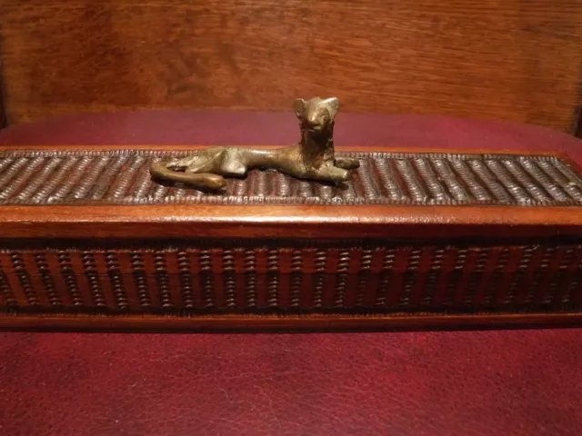 Lovely Cheetah Lounging atop Long Trinket Box