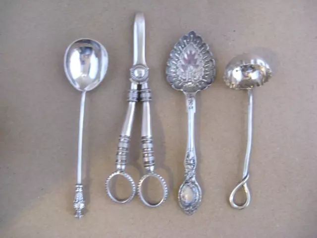 Antique silver plated items , grape scissors , sifter, spoons.