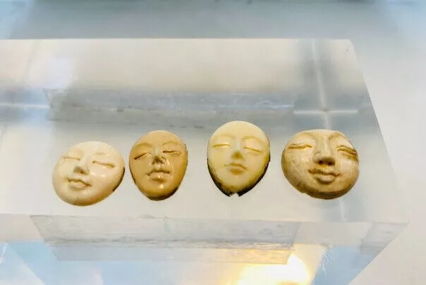 4 Antique carved faces.