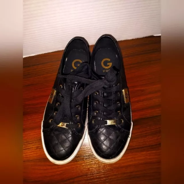 G by Guess black leather and gold tennis shoe