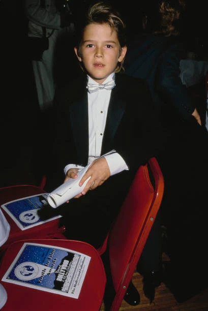 America child actor Brandon Call wearing a black shirt with a America child actor Brandon Call wearing a black shirt with a