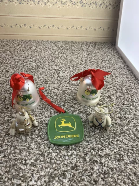 Three John Deer Christmas ornaments and two snowmen.