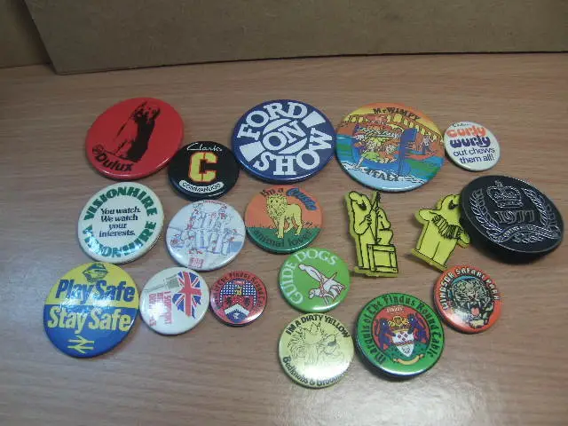 Group of 18 tin (and plastic) advertising Badges from the 1970s and 1980s