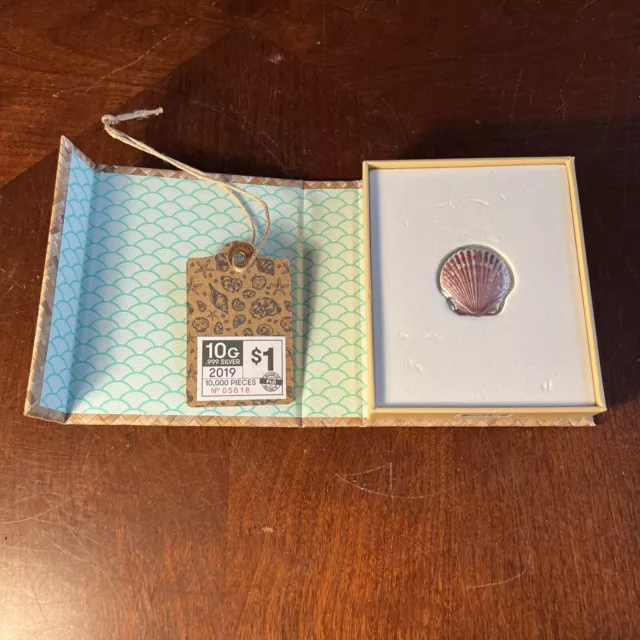 Scallop Shell 2019 $1 Fiji 10 Gram .999 Silver Colorized Coin In Castaway Box Scallop Shell 2019 $1 Fiji 10 Gram .999 Silver Colorized Coin In Castaway Box