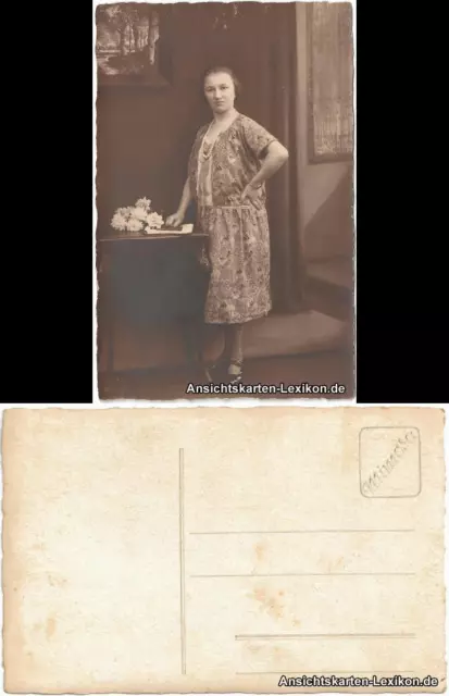 Postcard woman portrait with picture and flowers next to storage table 1940