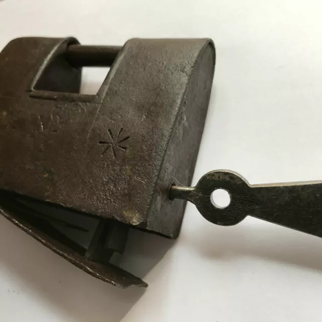 An old antique iron trick or puzzle padlock lock with barbed spring mechanism