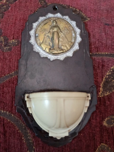 Antica acquasantiera in bachelite, con immagine in ottone della Madonna. Anni 30