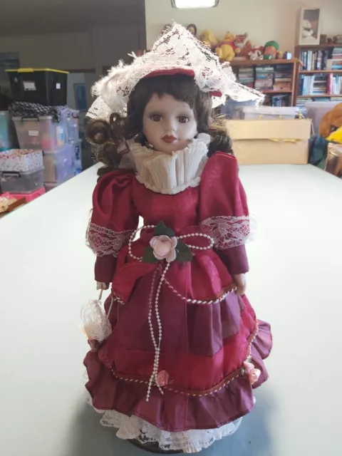 41cm Porcelain Doll, Brunette With Maroon Dress.