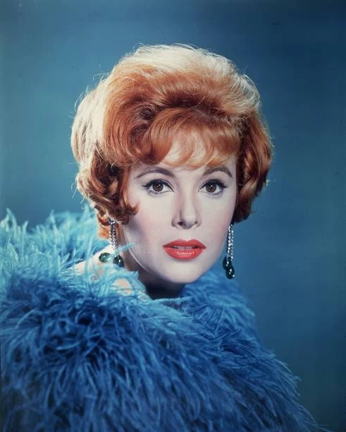 AMERICAN ACTOR JILL St John wearing a blue feather boa and drop - 1965