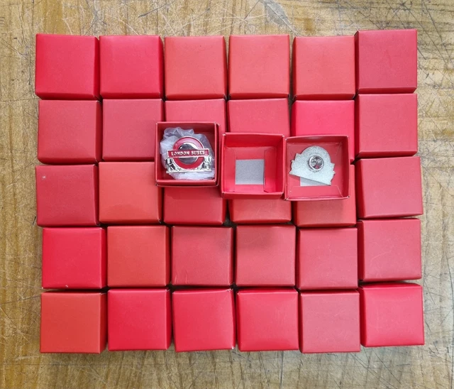 A Job Lot Collection  Of 32 Boxed London Buses Badges By Atlas Models.