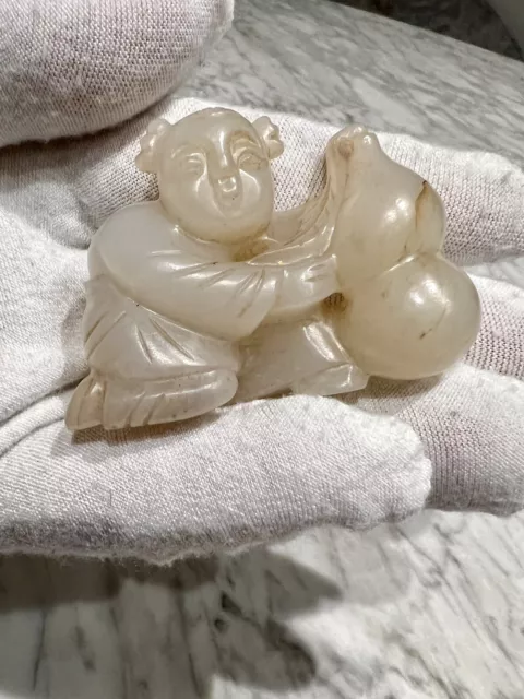 A magnificent Chinese Mutton Fat jade carving toggle of a Boy