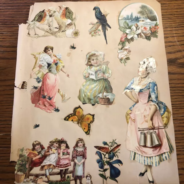 Página de libro de recortes troquelada de colección del siglo XIX con tarjetas victorianas y troquelados en ambos lados
