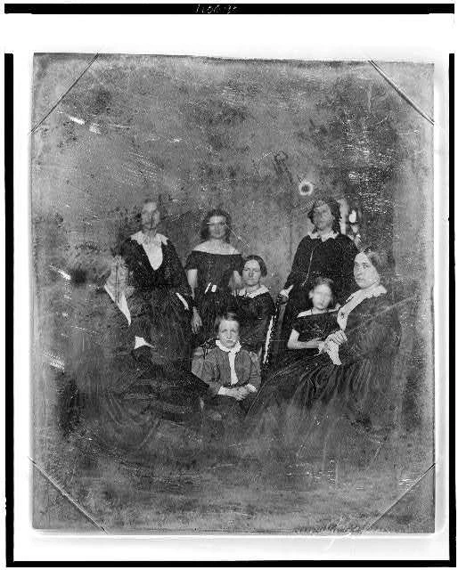 Unidentified group of six women,a boy,girl,three women,the boy are in chairs