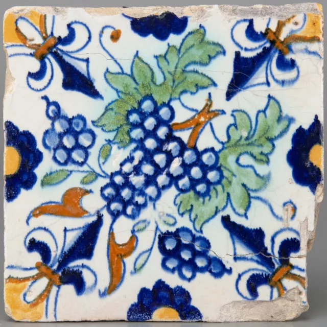 Nice Dutch Delft polychrome ornament tile grapes, early 17th. century.