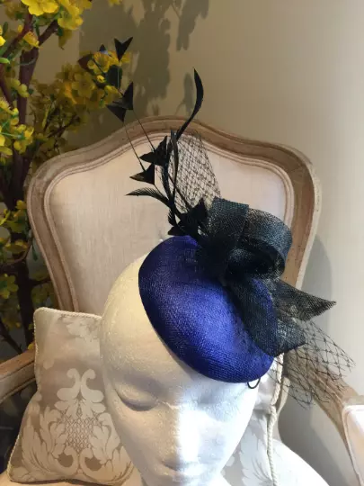 Beautiful royal blue fascinator base with black loops, netting and feathers!