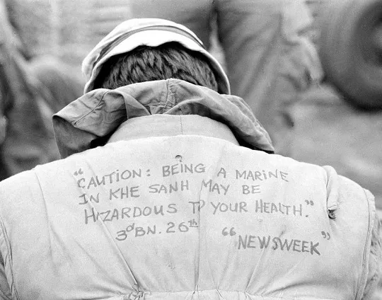 U.S. Marine shows a message on his flack vest 8"x 10" Vietnam War Photo 108