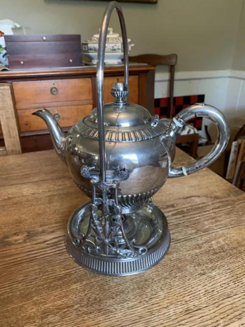 https://www.picclickimg.com/ATcAAOSwQKJlLYBp/Victorian-Tilting-Teapot-Stand-Warmer-Quad-Silver-Plate.webp