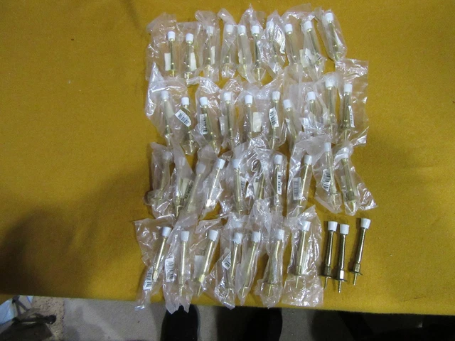 Doorstops:  40 brass colored peg style stops: new in packaging:  25 cents each