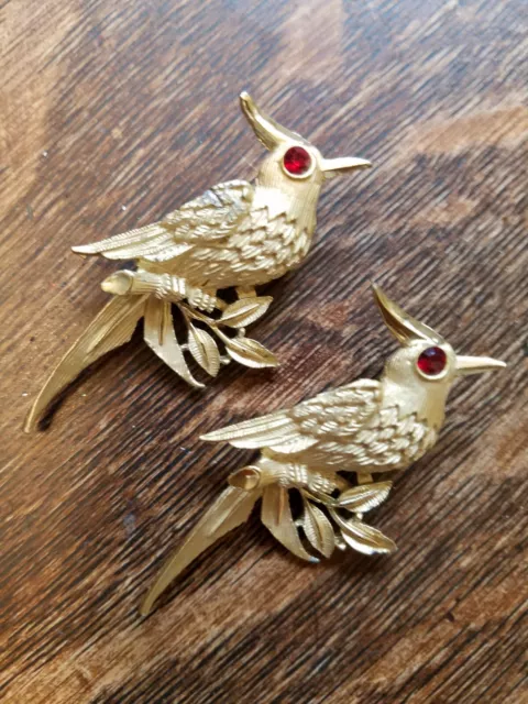 Vintage pair of gold tone blue jay bird brooch pins with red rhinestone eye