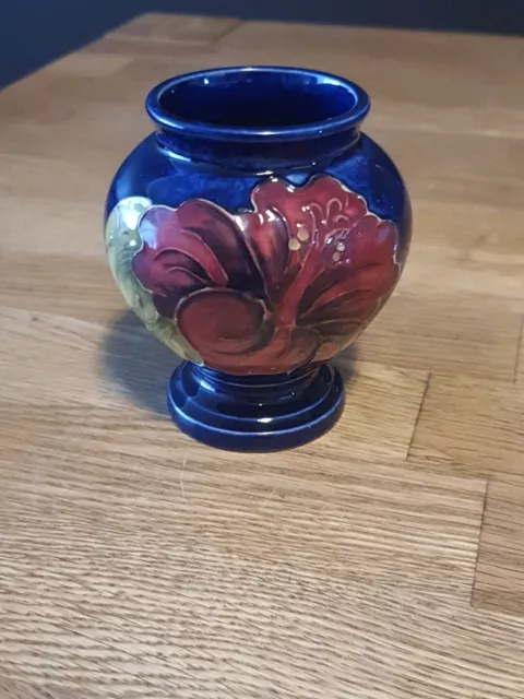 Small Moorcroft Hibiscus Pattern Footed Vase.