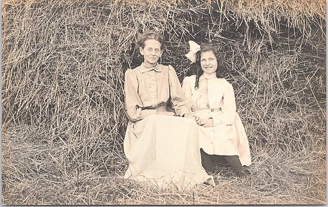 RPPC Grandmother & Granddaughter posing in front of Hay Stack early 1900s