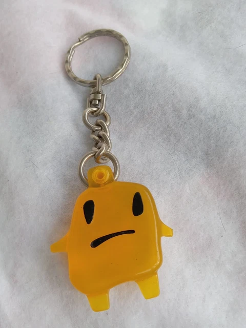Sad faced figural butterscotch colored key chain