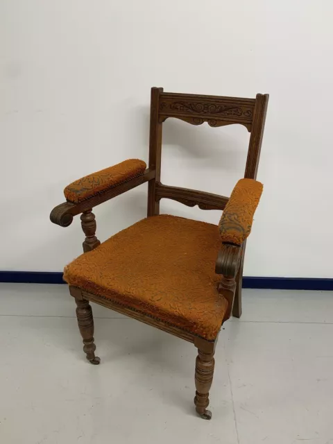 An Antique English Victorian Carved Upholstered Library / Bedroom Chair.