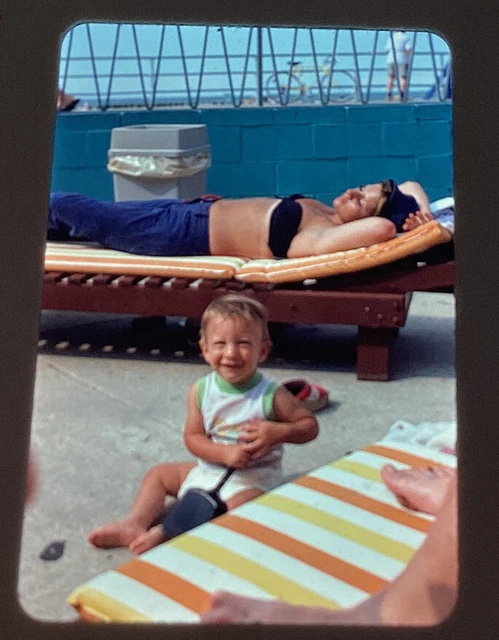 slide photo Vintage 1974 woman tanning tube top watching son sun bath mom