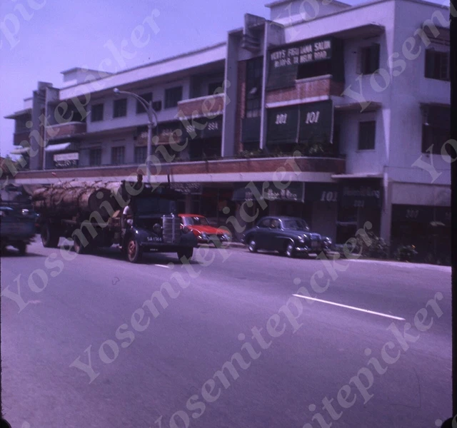 Sl68 Original slide 1967 Indonesia downtown traffic stores 504a